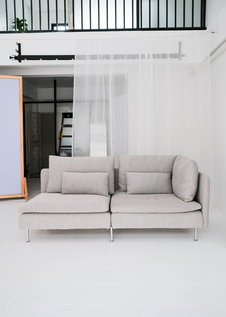 Lifestyle photo studio in Chiang Mai showing a minimalist grey sofa setup